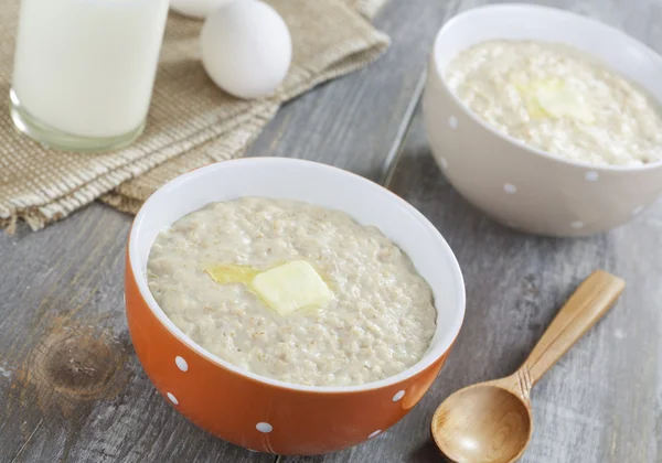 Oatmeal porridge with butter, milk and eggs — Stock Photo, Image