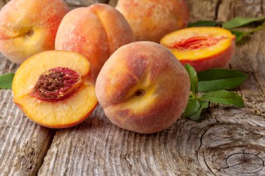 Group of fresh peaches on wood background clipart