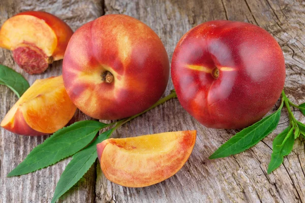 Fresh nectarines on wooden background — Stock Photo, Image