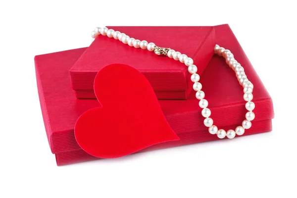 Gift boxes with red heart and pearl necklace isolated on white — Stock Photo, Image