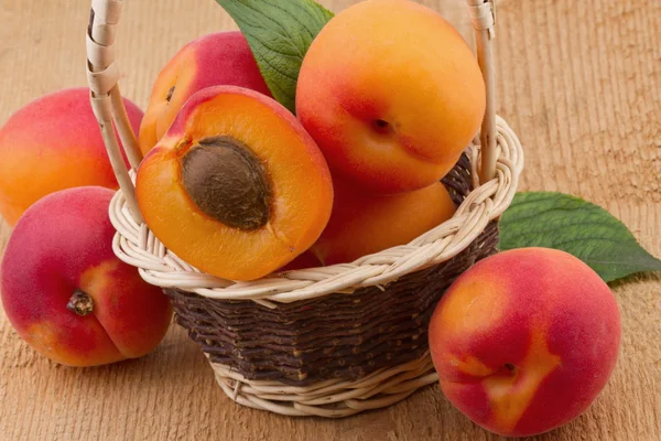 Apricot in basket on wooden background — Stock Photo, Image