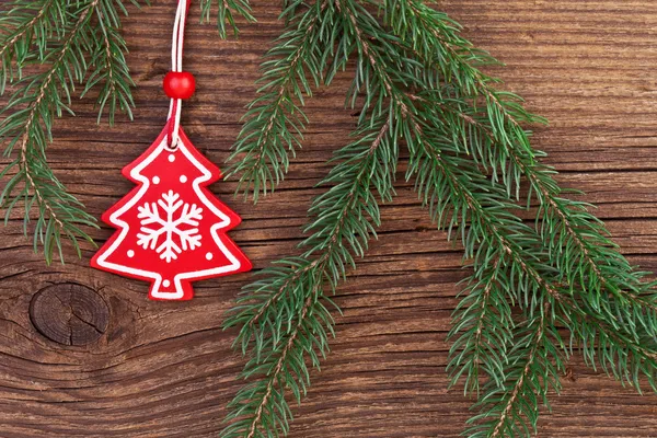 Christmas decoration with fir branch over wooden background — Stock Photo, Image