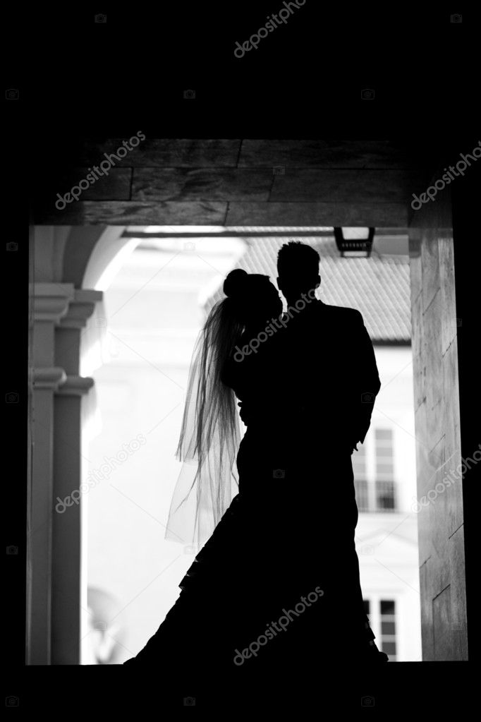 Silhouette of groom and bride