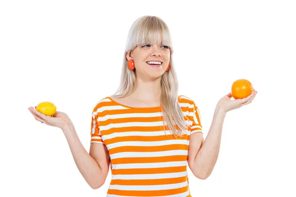 Beautiful girl choosing between fruit — Stock Photo, Image