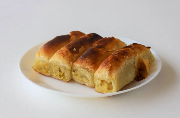 Turkish style potato pie in the form of a roll, made by wrapping dough.