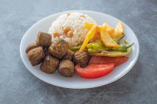 Vegetable patties for vegan burgers in plate, gray marble background.