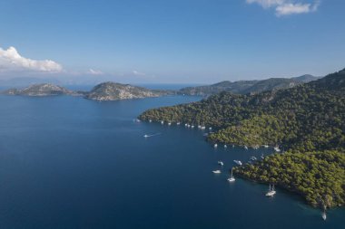 sarsala beach bay dalaman Mediterranean bay with hills and pine forest blue water and boats