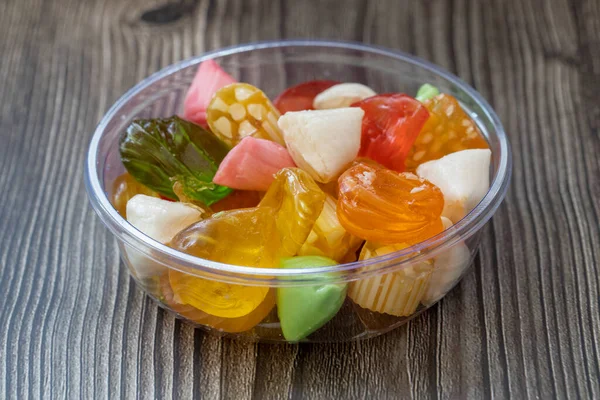 Colorful candies in a glass bowl , hard candy .