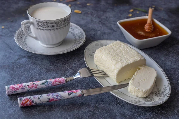Clotted cream (butter cream) for Turkish breakfast - Kaymak, honey and glass of milk