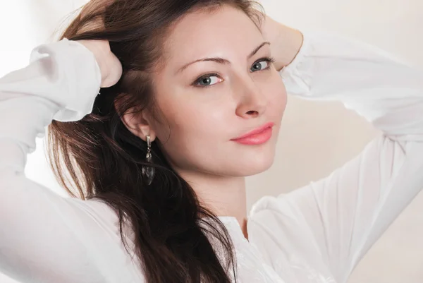 Portrait of young girl with hands in her hair — Stock Photo, Image