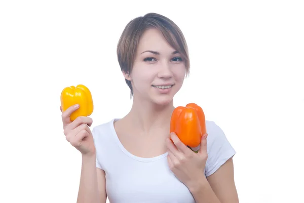 Pretty young girl with red and yellow peppers — Stock Photo, Image