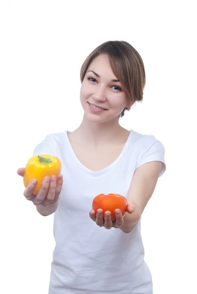 Pretty young girl with red and yellow peppers — Stock Photo, Image