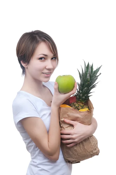 Girl with package of fruits and green apple — Stock Photo, Image