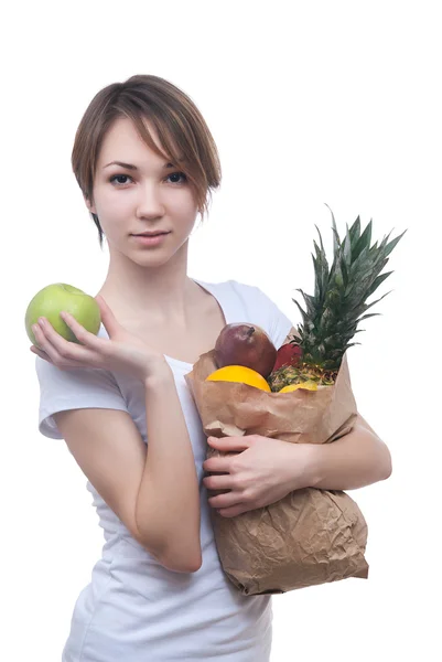 Meisje met pakket van fruit en groene appel — Stockfoto