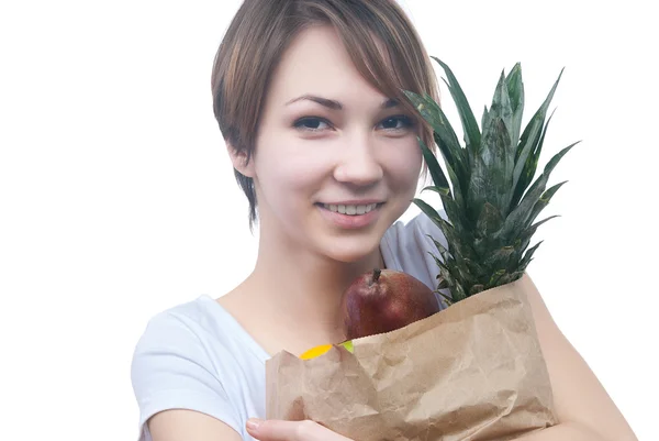 Chica con paquete de frutas y manzana verde — Foto de Stock