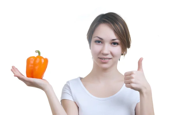 Vrij jong meisje met oranje peper — Stockfoto