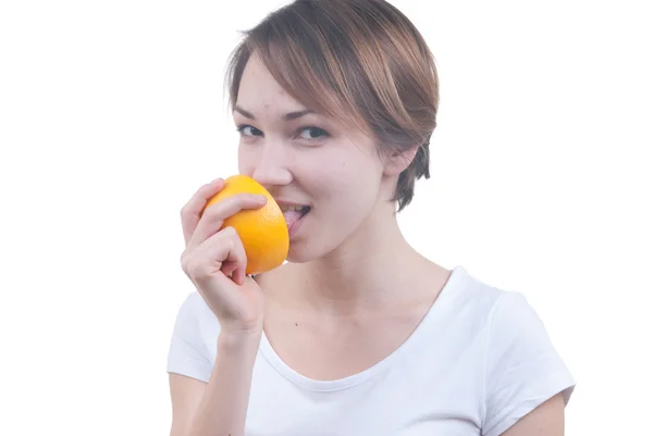 Girl licking half of grapefruit — Stock Photo, Image