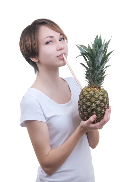 Girl drinks juice from pineapple — Stock Photo, Image