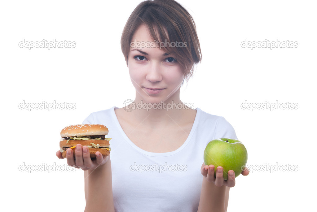 Girl makes choice between apple and hamburger