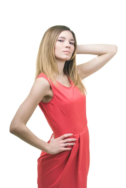 Chica joven en un vestido rojo sobre un fondo blanco — Foto de Stock