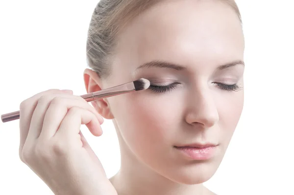 Girl with eyelid brush, isolated on white — Stock Photo, Image