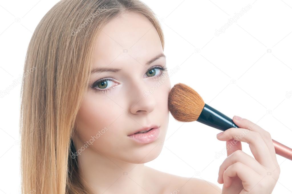 Beauty photo of girl with makeup brush.