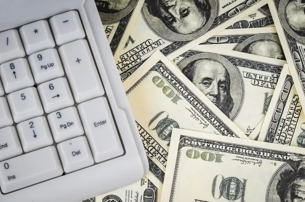 Keyboard on background of one hundred dollars notes — Stock Photo, Image