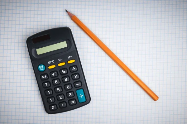 Calculator and pencil on the sheet of paper — Stock Photo, Image