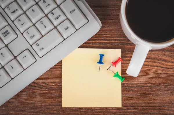 Cup of coffee, sticker and keyboard — Stock Photo, Image