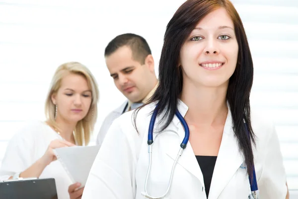 Portrait of young nurse, behind the colleagues — Stock Photo, Image