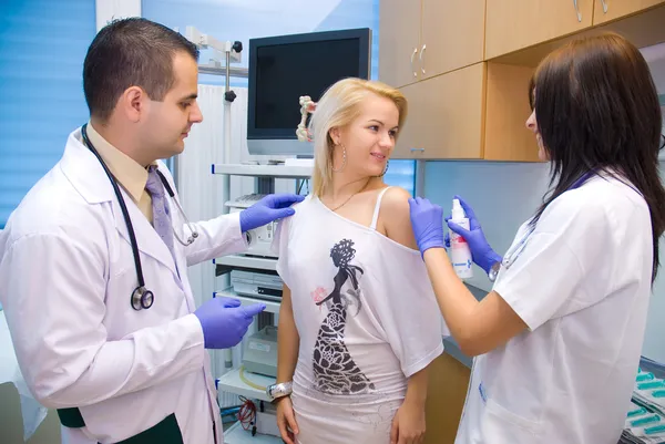 Two doctors examining a patient — Stock Photo, Image
