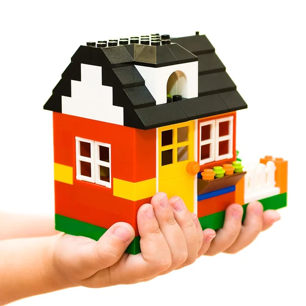 A girl holding a house in the hands of the designer Stock Picture