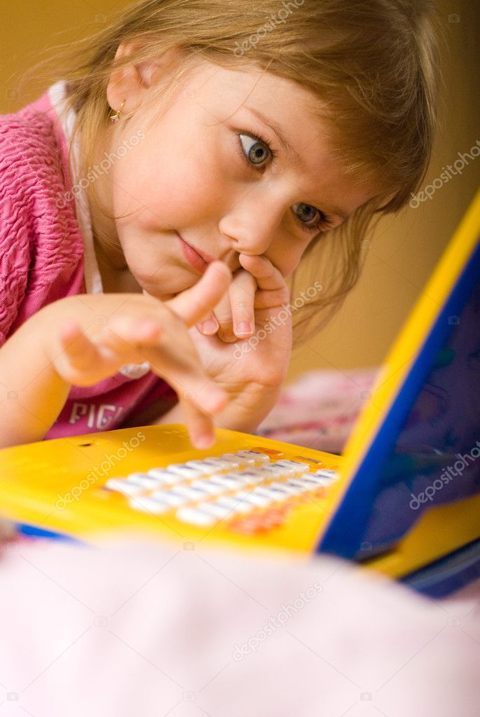 Young girl thinks before laptops