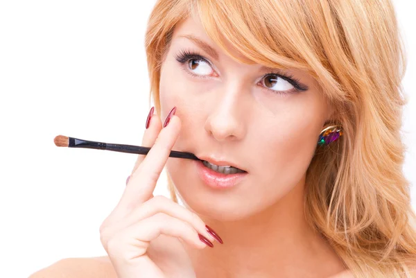 Beautiful blonde woman with makeup brush — Stock Photo, Image