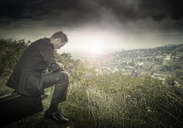Lonely businessman on the hillside — Stock Photo, Image