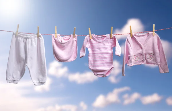 Clean baby girl clothes on the outdoor clotheslin — Stock Photo, Image