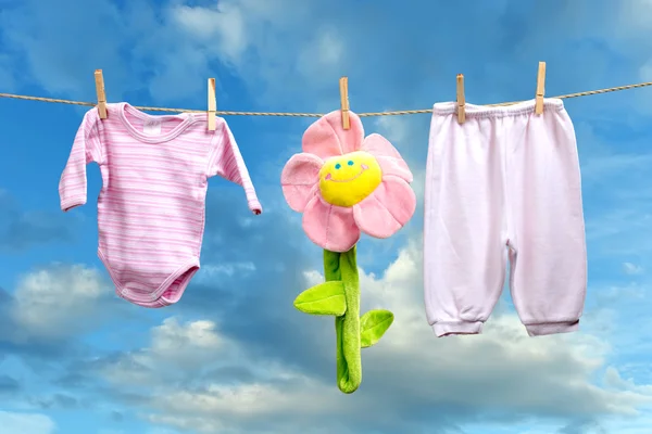 Baby girl clothes with flower on the clothesline — Stock Photo, Image