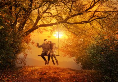 Romantic couple swing in the autumn park clipart