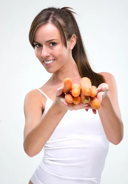 Beautiful woman holding carrot — Stock Photo, Image