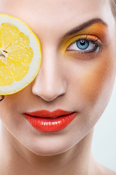 Beautiful woman with lemon and yellow makeup