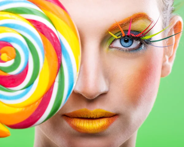 Colorful twisted lollipop, colorful fashion makeup — Stock Photo, Image