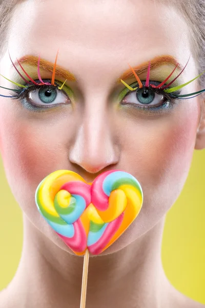 Woman with lollipop and extreme makeup — Stock Photo, Image