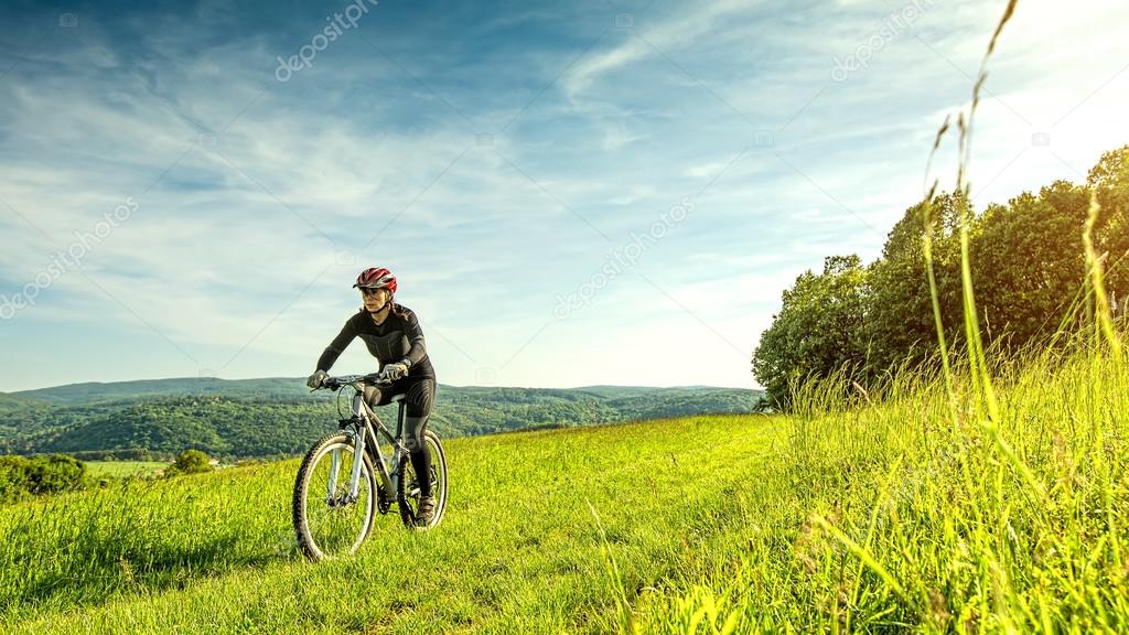 Sport bike woman in a beautiful meadow