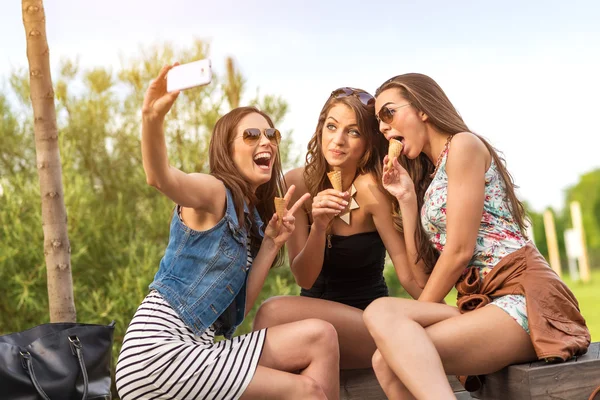 Three beautiful girlfriends eating ice cream while Selfie photo — Stock Photo, Image