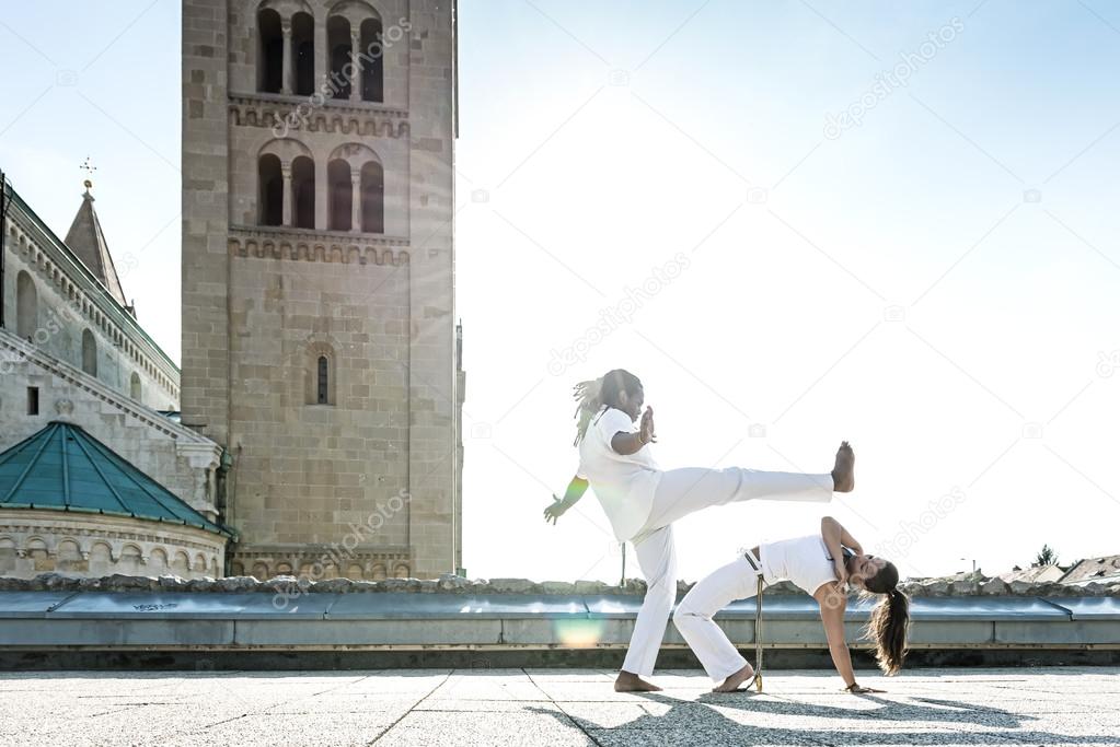 Capoeira performers doing kicking