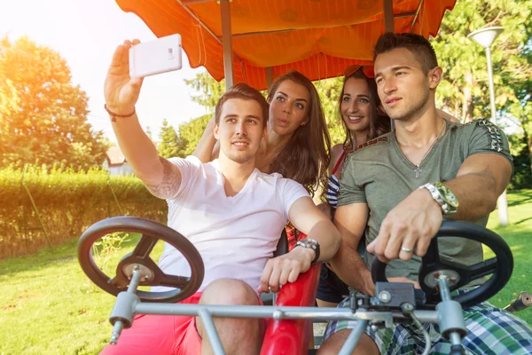 People in a four-wheeled bicycle — Stock Photo, Image