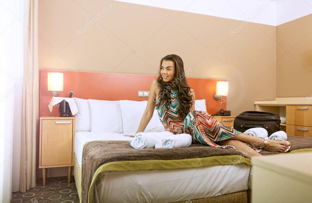 Woman in the bed of a hotel room