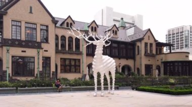 Tokyo, Japonya - 14 Eylül 2019: Sanatçı Kohei Nawa tarafından Tokyo Garden Terrace Kioicho 'nun önünde yaratılan Beyaz Geyik adlı halk sanatı heykelinin Pan videosu.