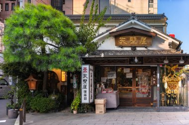 tokyo, japan - september 17 2019: Amanoya Cafe at Kanda-myojin famous for Amazake fermented rice drink with a traditional architecture adorned with ranma at doors and a portable Mikoshi Shinto shrine.