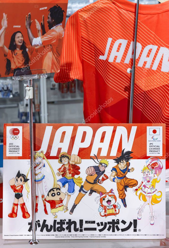 Tokyo, japan - september 21 2021: T-shirt and cardboard on a stall of Olympics Store with Japanese manga or anime characters Astro Boy, Sailor Moon, Luffy, Naruto, Son Goku and slogan Go for it Japan.